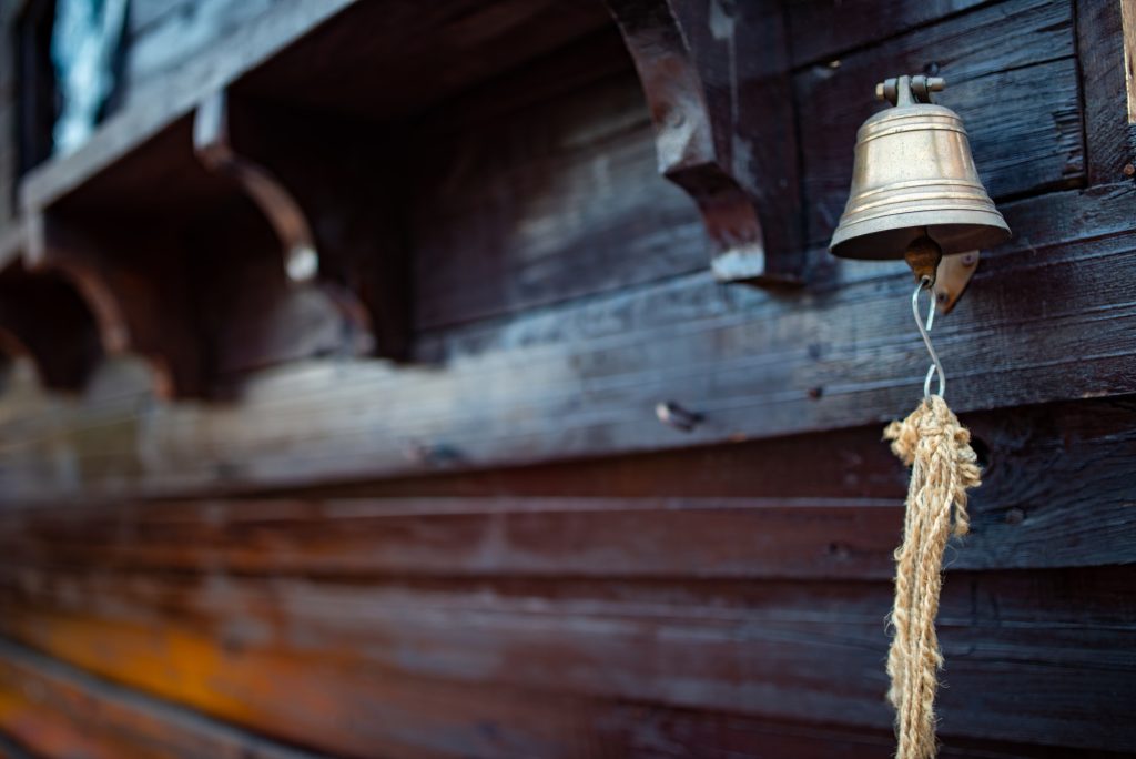 Bell with a rope hangs on the hull