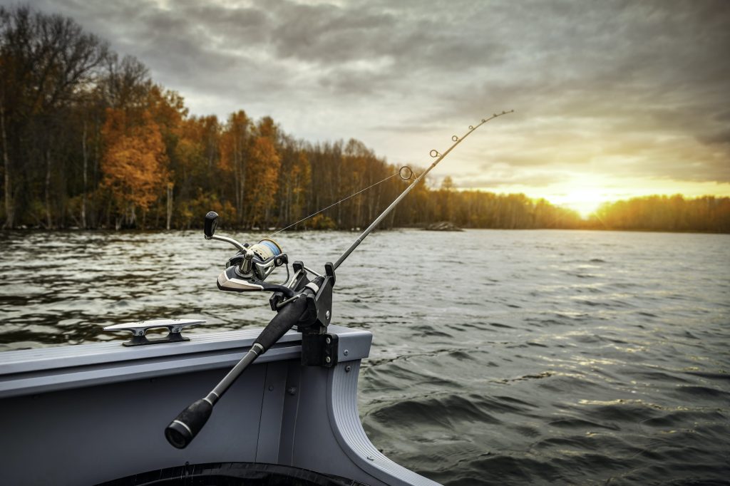 Fishing rod on the boat. Autumn season