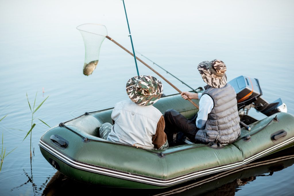 Grandfather with son fishing on the boat