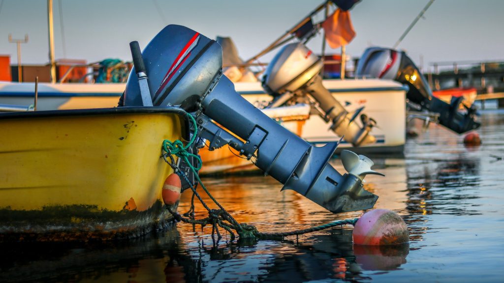 Shot of colorful boats with boat motors on the water surface