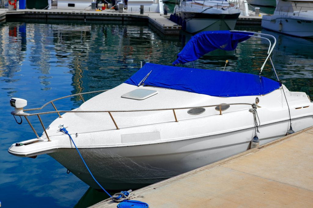 Small luxury motor boat parked at the pier